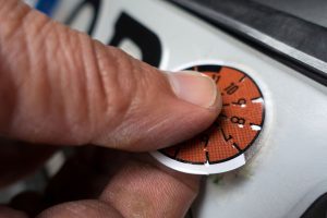 Hand,From,Tüv,Agent,Sticking,New,Tüv,Seal,On,Car